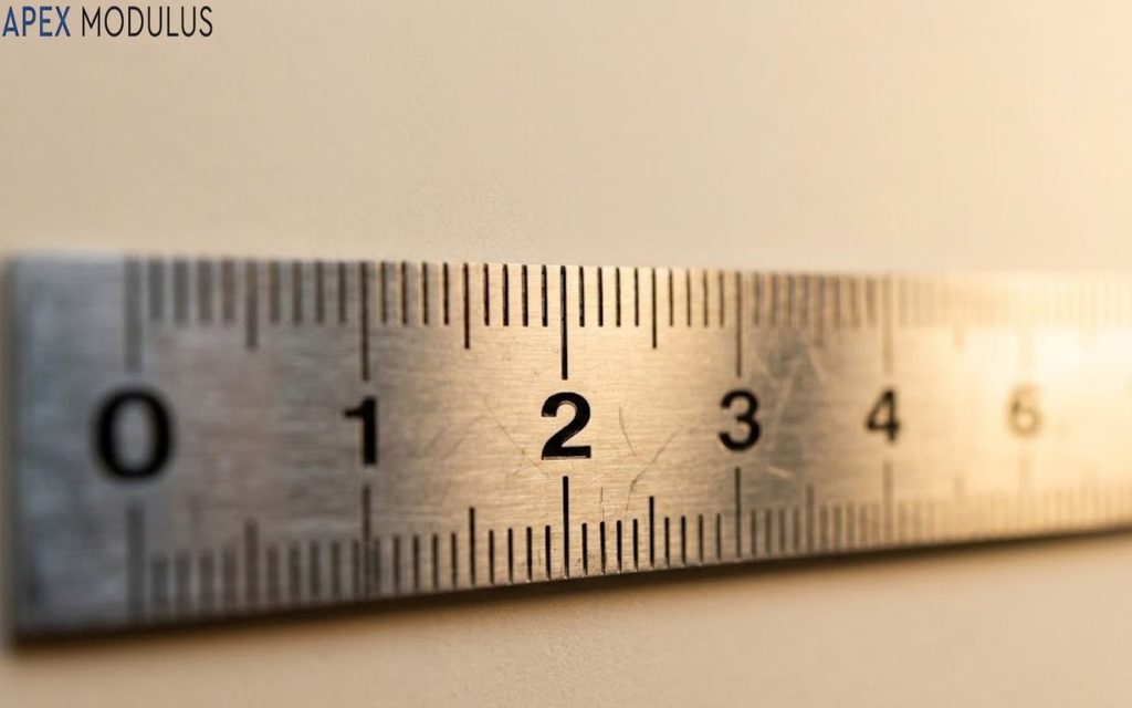 Close-up of a metal ruler showing metric millimeter and centimeter markings from 0 to 7, with the number 2mm noticeably clear
